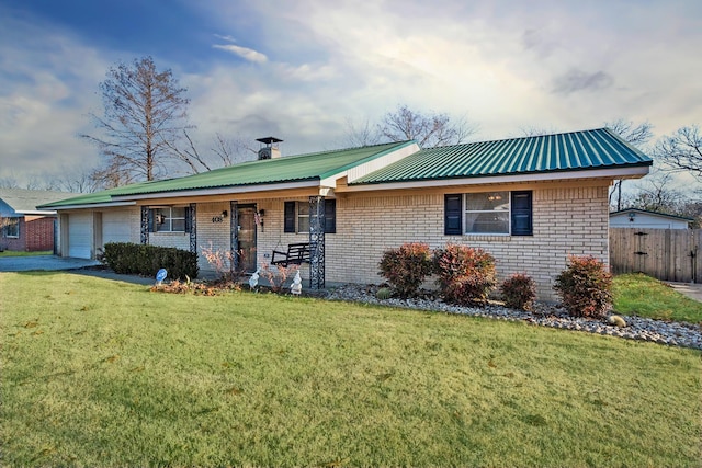 ranch-style house featuring a porch, a garage, and a front yard