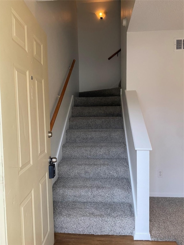 stairway featuring hardwood / wood-style floors