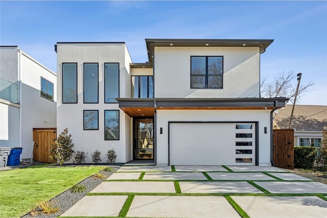 contemporary house with a garage and a front yard