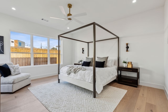 bedroom with ceiling fan and light hardwood / wood-style flooring