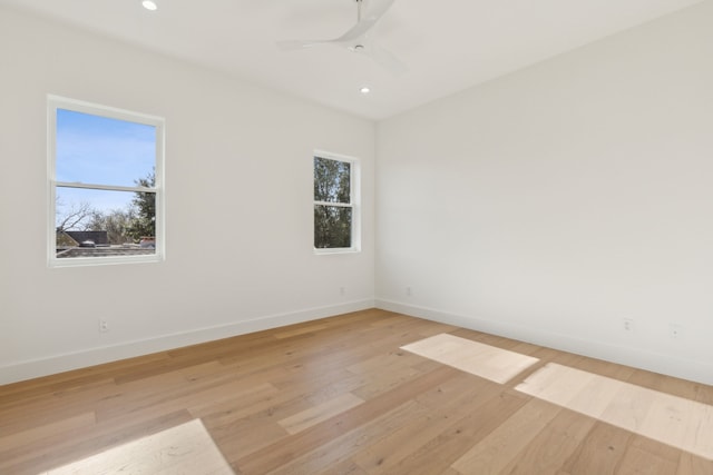 unfurnished room featuring plenty of natural light, ceiling fan, and light hardwood / wood-style flooring