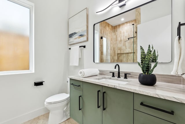 bathroom featuring vanity, toilet, and walk in shower