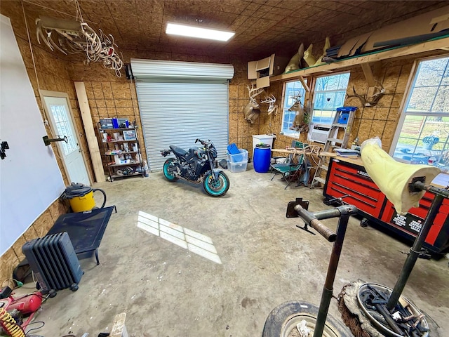 interior space featuring cooling unit, concrete flooring, and a workshop area