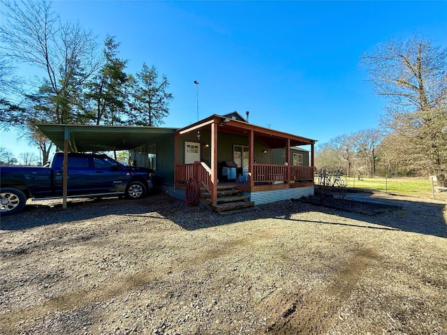 view of front facade with a porch and a carport