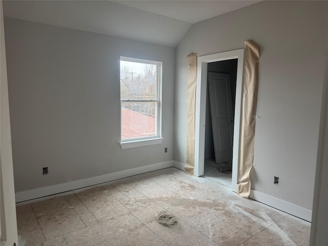 unfurnished bedroom featuring vaulted ceiling