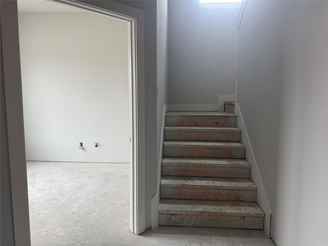 stairway featuring concrete floors