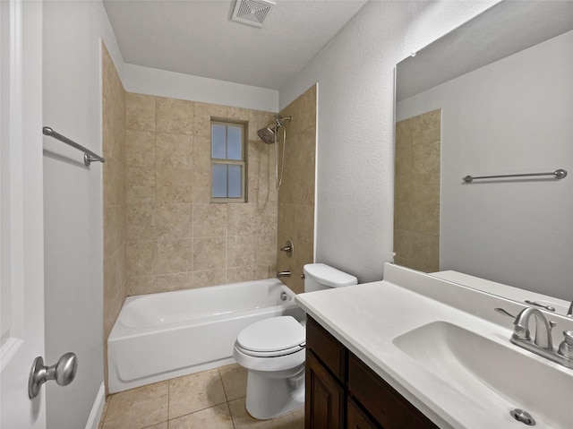 full bathroom featuring tiled shower / bath combo, vanity, tile patterned floors, and toilet