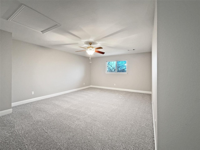 carpeted spare room featuring ceiling fan