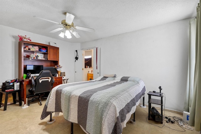 bedroom featuring ceiling fan and a textured ceiling