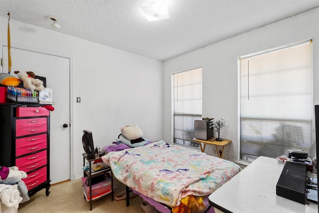 carpeted bedroom featuring a textured ceiling