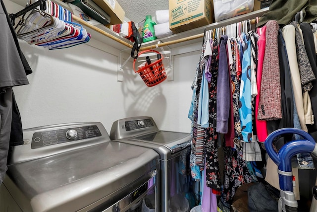 clothes washing area featuring independent washer and dryer and a textured ceiling