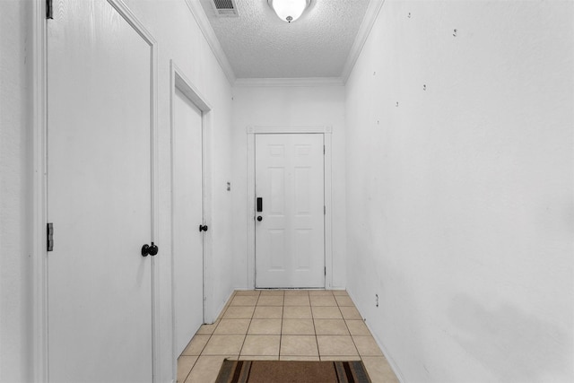 hallway featuring ornamental molding, light tile patterned flooring, and a textured ceiling