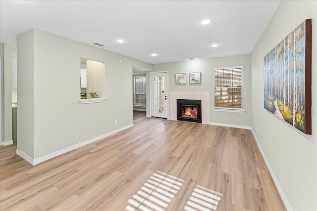 unfurnished living room with light wood-type flooring