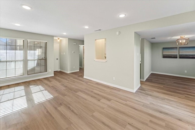 unfurnished room with light wood-type flooring