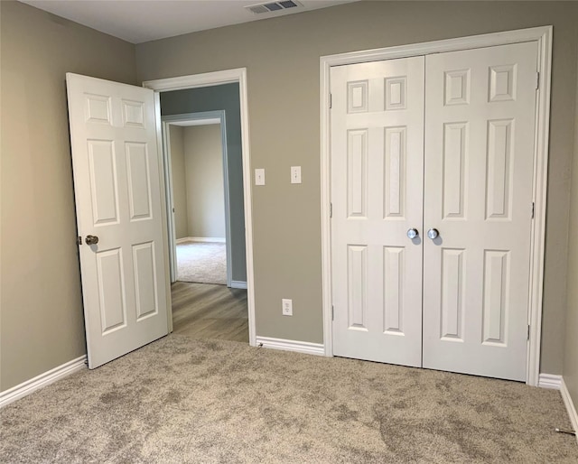 unfurnished bedroom with carpet floors and a closet