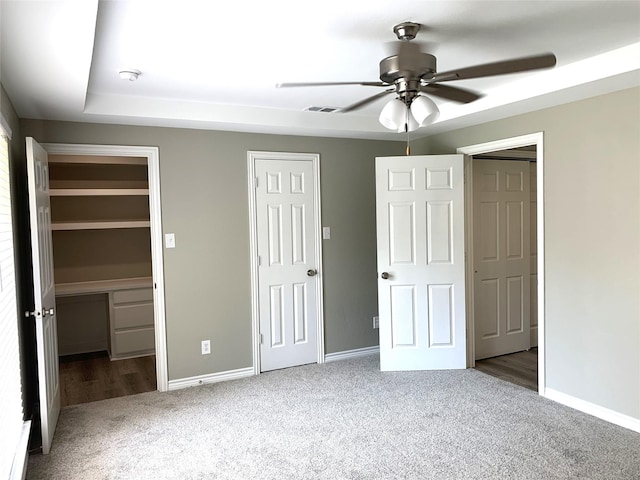 unfurnished bedroom with ceiling fan and carpet