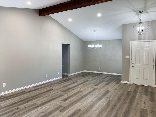 interior space featuring an inviting chandelier, lofted ceiling with beams, and hardwood / wood-style flooring