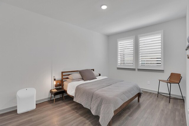 bedroom with dark hardwood / wood-style flooring and a closet