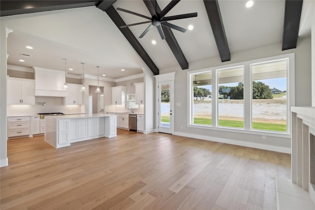 unfurnished living room with high vaulted ceiling, sink, beam ceiling, and light hardwood / wood-style floors