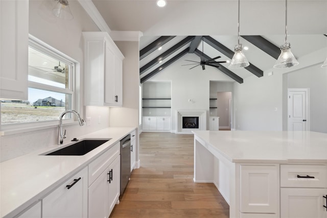 kitchen with sink, dishwasher, ceiling fan, white cabinetry, and light hardwood / wood-style floors