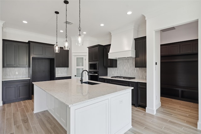 kitchen featuring crown molding, custom range hood, stainless steel appliances, a large island, and backsplash