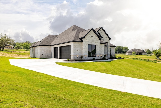 french country home featuring a garage and a front yard