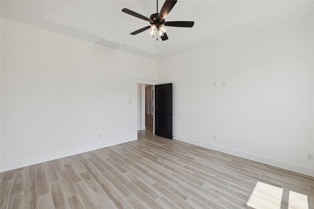 spare room featuring ceiling fan and light hardwood / wood-style flooring