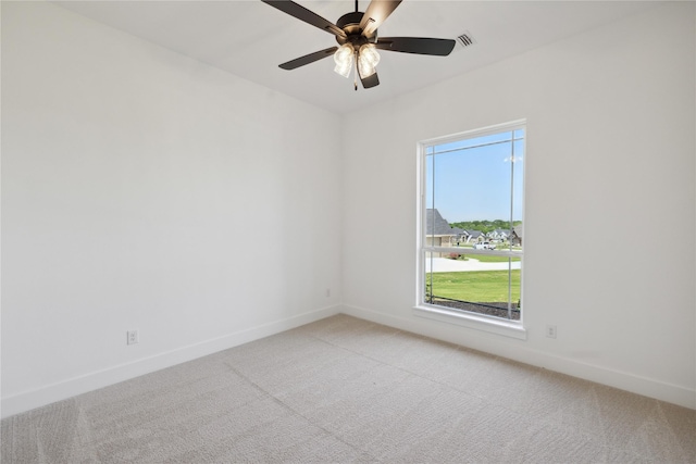 spare room with ceiling fan and carpet