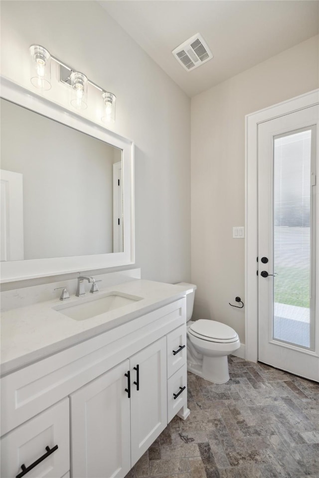 bathroom featuring vanity and toilet