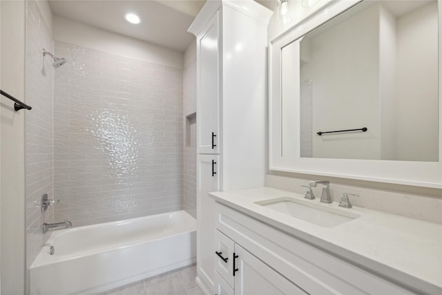 bathroom with vanity and tiled shower / bath combo