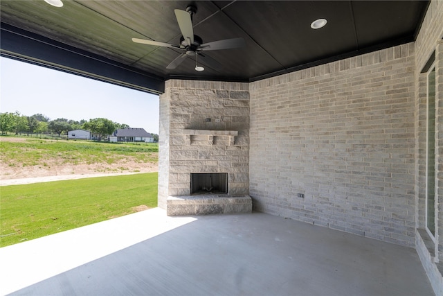 view of patio / terrace with ceiling fan and an outdoor stone fireplace