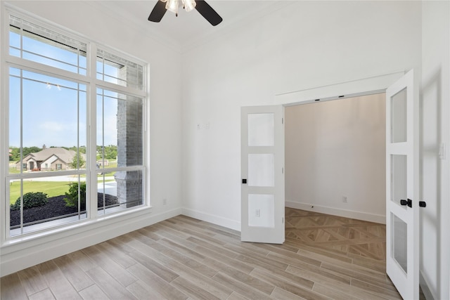 unfurnished room featuring ornamental molding, ceiling fan, and light wood-type flooring