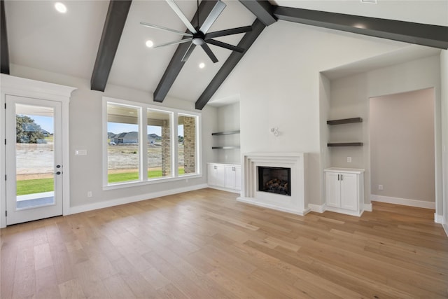 unfurnished living room featuring beamed ceiling, high vaulted ceiling, light wood-type flooring, and built in shelves