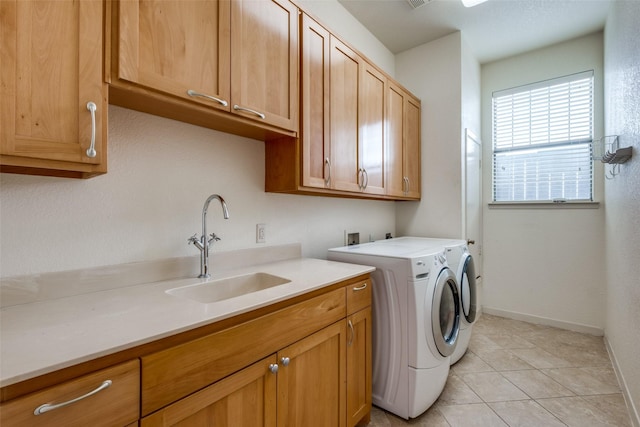 2002 Moser Ave, Dallas, TX 75206 - clothes washing area with sink, light tile patterned floors, washing machine and dryer, and cabinets