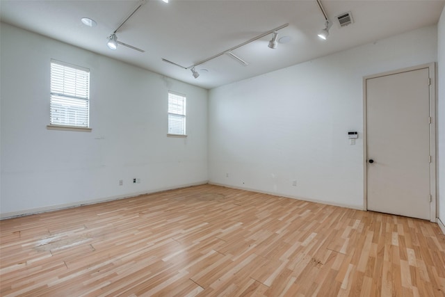 2002 Moser Ave, Dallas, TX 75206 - unfurnished room featuring rail lighting and light wood-type flooring
