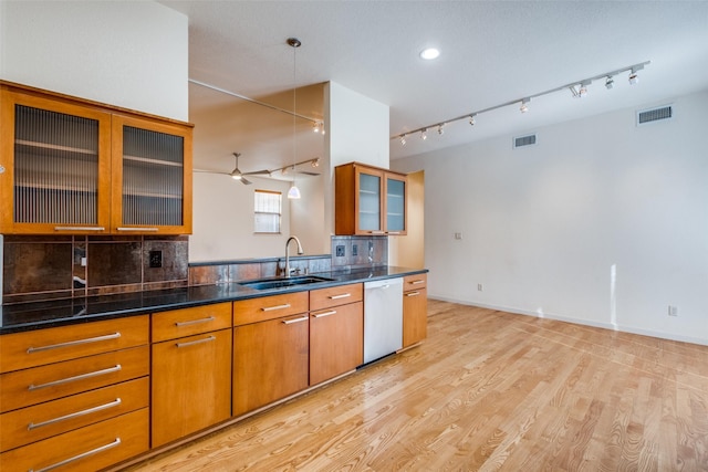 2002 Moser Ave, Dallas, TX 75206 - kitchen with sink, tasteful backsplash, decorative light fixtures, stainless steel dishwasher, and dark stone counters