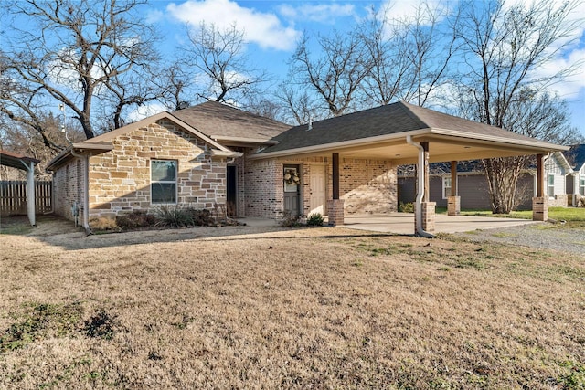 ranch-style home featuring a carport and a front lawn