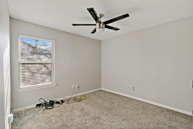 spare room featuring carpet and ceiling fan