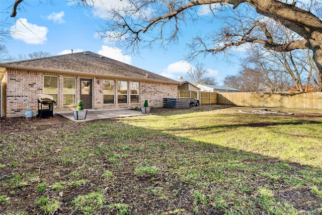 rear view of property featuring a patio area and a lawn