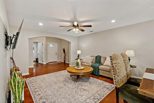 living room with ceiling fan and dark hardwood / wood-style floors