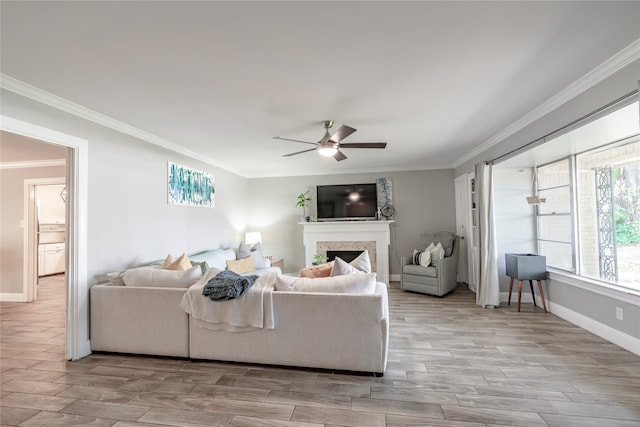 living room featuring ornamental molding and ceiling fan