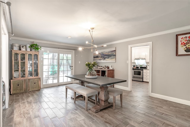 dining area featuring crown molding, hardwood / wood-style flooring, and a chandelier