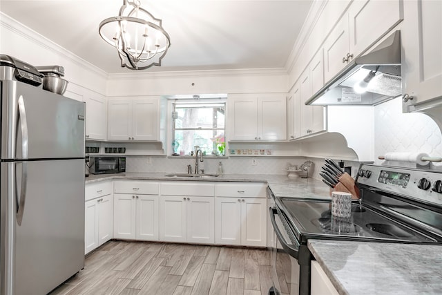 kitchen with appliances with stainless steel finishes, pendant lighting, sink, white cabinets, and ornamental molding