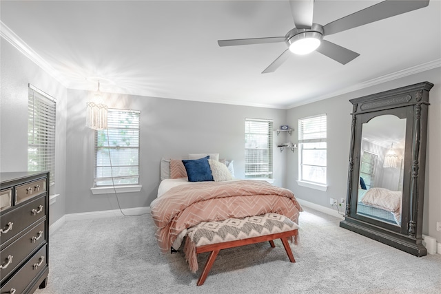 carpeted bedroom with crown molding and ceiling fan