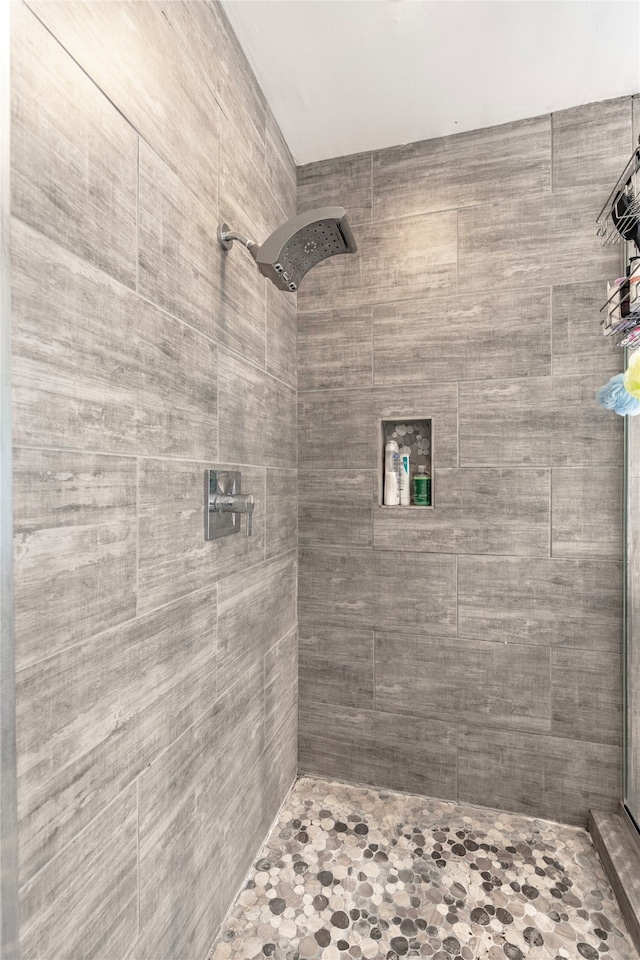 bathroom with tiled shower