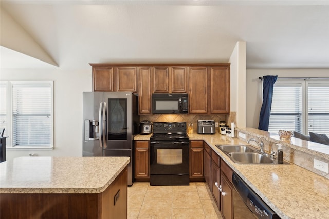 kitchen featuring sink, light tile patterned floors, backsplash, black appliances, and kitchen peninsula