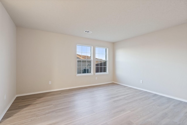 unfurnished room with light wood-type flooring