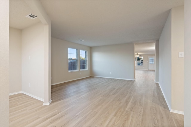 empty room with light hardwood / wood-style floors