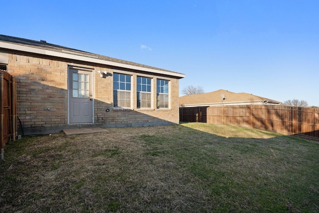 back of house featuring a lawn