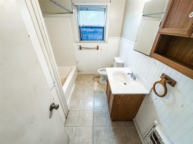 bathroom featuring vanity, tile patterned flooring, and toilet